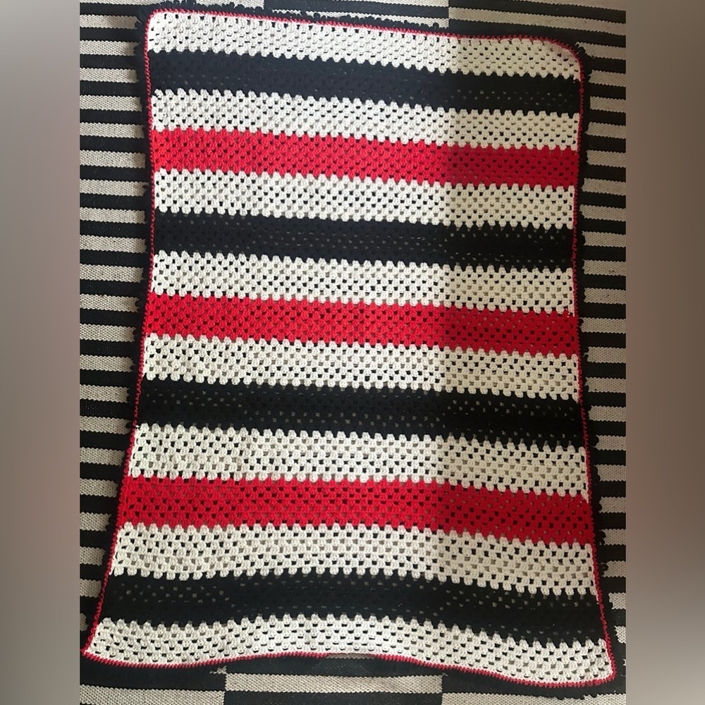 Crochet afghan in red white black stripes